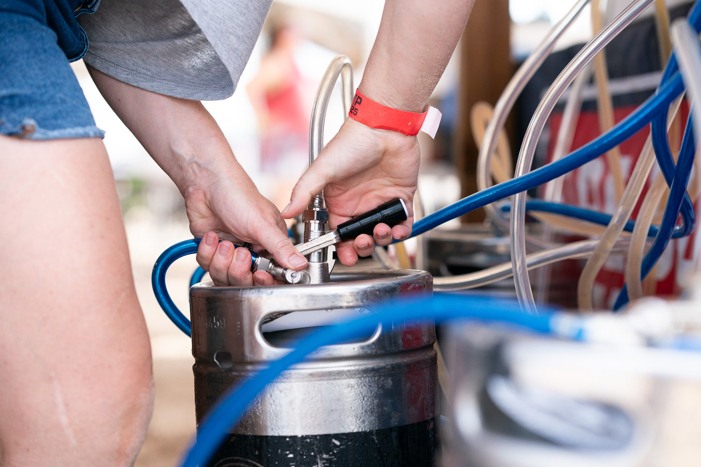 person connecting dispensing kit to Coldbreak jockey box at festival